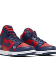 A pair of the Nike sb dunk high supreme skating shoes in red navy colour