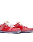 A pair of the Nike sb dunk low stingwater magic mushroom skating shoes in red and white