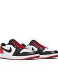 Pair of Jordan 1 Retro Low OG Black Toe in black, red and white.
