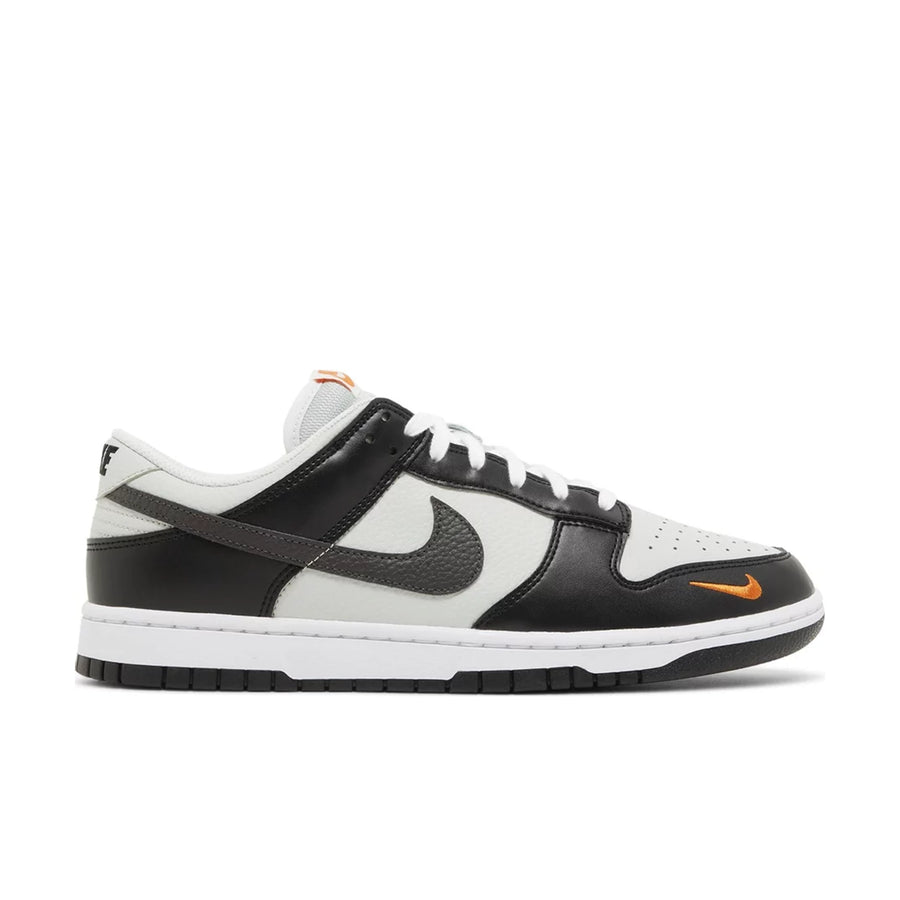 Side of Nike Dunk Low Black Total Orange Mini Swoosh in black, white and orange.