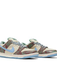 Pair of Nike SB Dunk Low Crenshaw Skate Club in sail and blue.