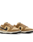 Pair of Nike Dunk Low Dark Driftwood (W) in brown and beige.