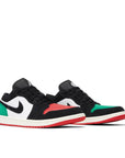 Pair of Jordan 1 Low Quai 54 (2023) in red, green, black and white.