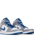 pair of Jordan 1 mid true blue in blue, grey and white
