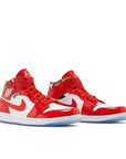 A pair of Nike Air Jordan 1 Mid Barcelona basketball shoes red and white