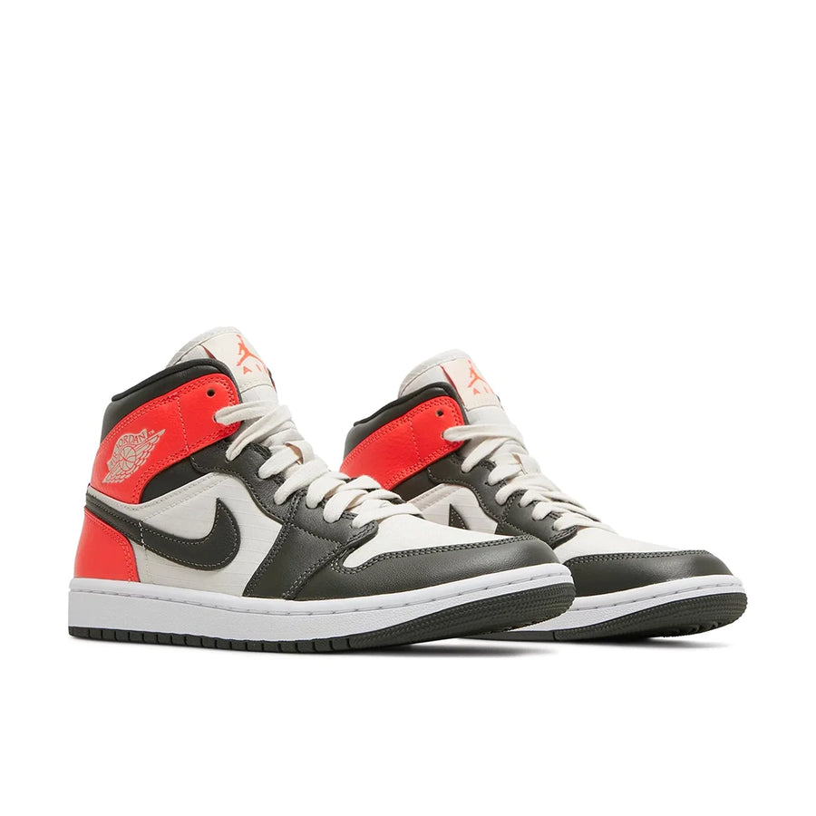 A pair of Jordan 1 Mid 'light Orewood Brown' is in a black and red colourway