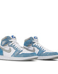 A pair of Nike Air Jordan 1 Retro High Hyper Royal Michael Jordans in white and washed out royal blue