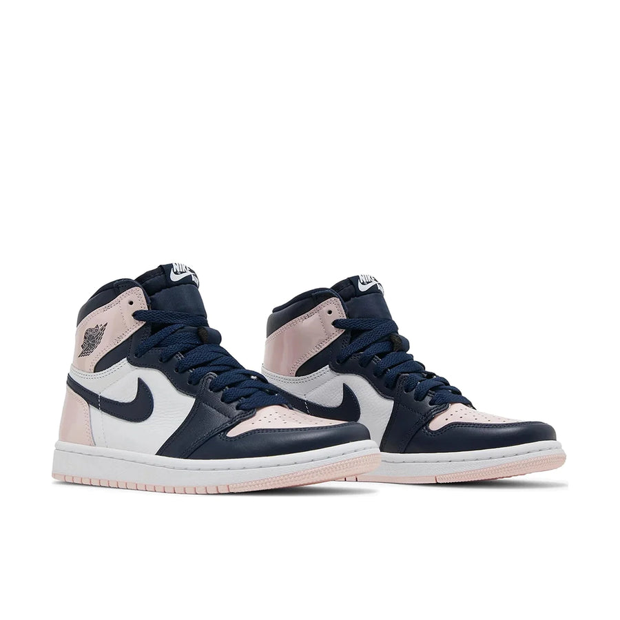 A pair of Nike Air Jordan 1 High Atmosphere basketball shoes are in pink, black and white.