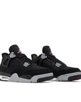 A pair of the Nike Air Jordan 4 retro black canvas basketball shoes are in an all black colourway.