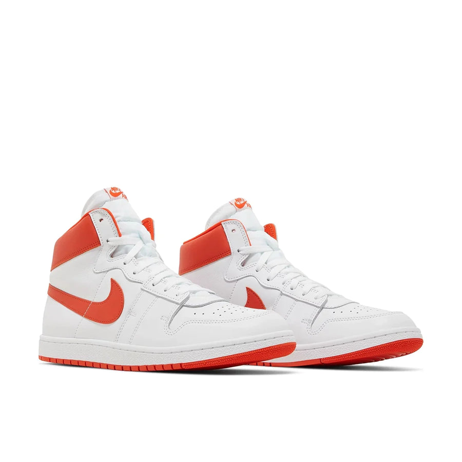 A pair of Nike Air Ship Team Orange basketaball sneakers in white and orange