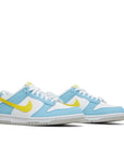 A pair of gradeshool Nike Dunk Low Next Nature Homer Simpson GS childrens sneakers in white, blue and yellow