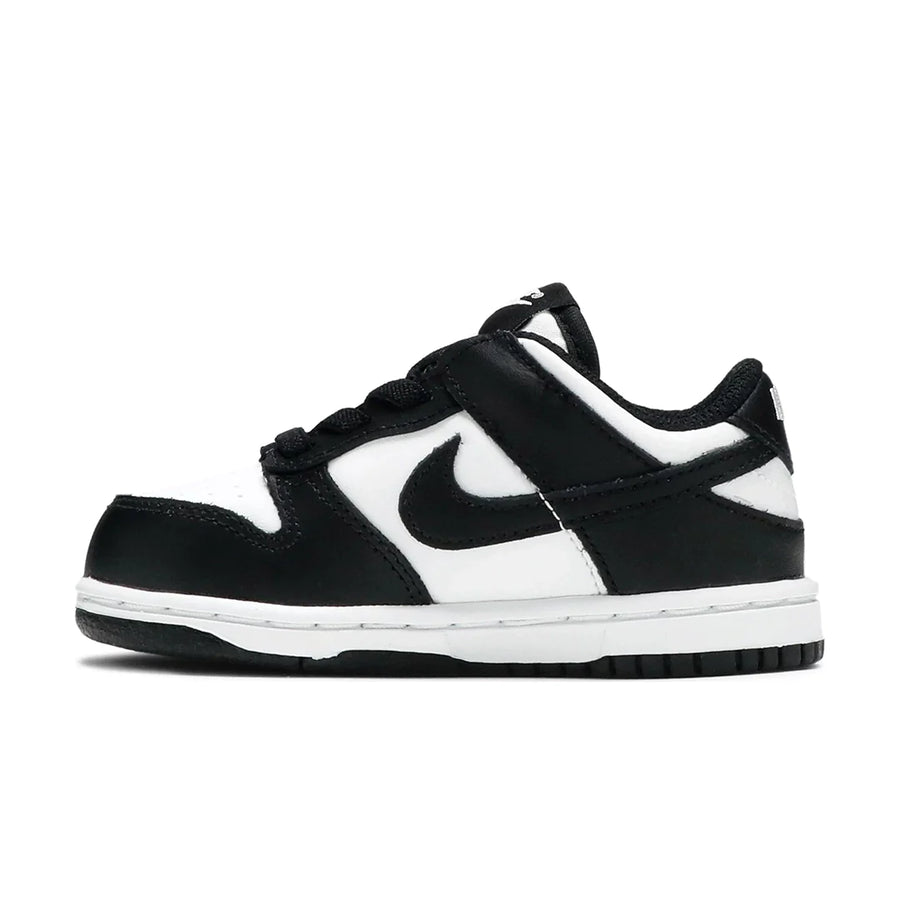 Side of the toddler version of the Nike dunk low in a black white "Panda" colour