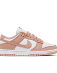 Side of the womens Nike dunk low in a white peach "rose whisper" colour