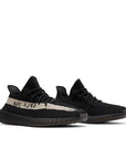 A pair of adidas Yeezy Boost 350 v2 Core Black White sneakers