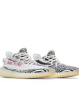 A pair of adidas Yeezy Boost 350 v2 Zebra sneakers