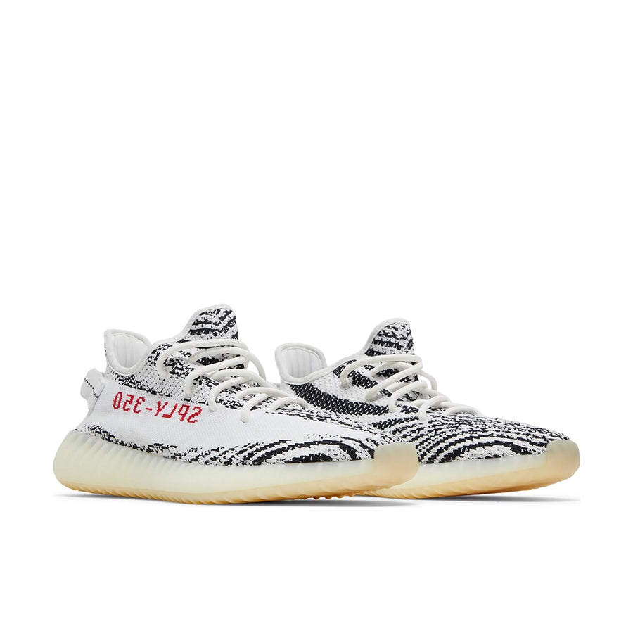 A pair of adidas Yeezy Boost 350 v2 Zebra sneakers