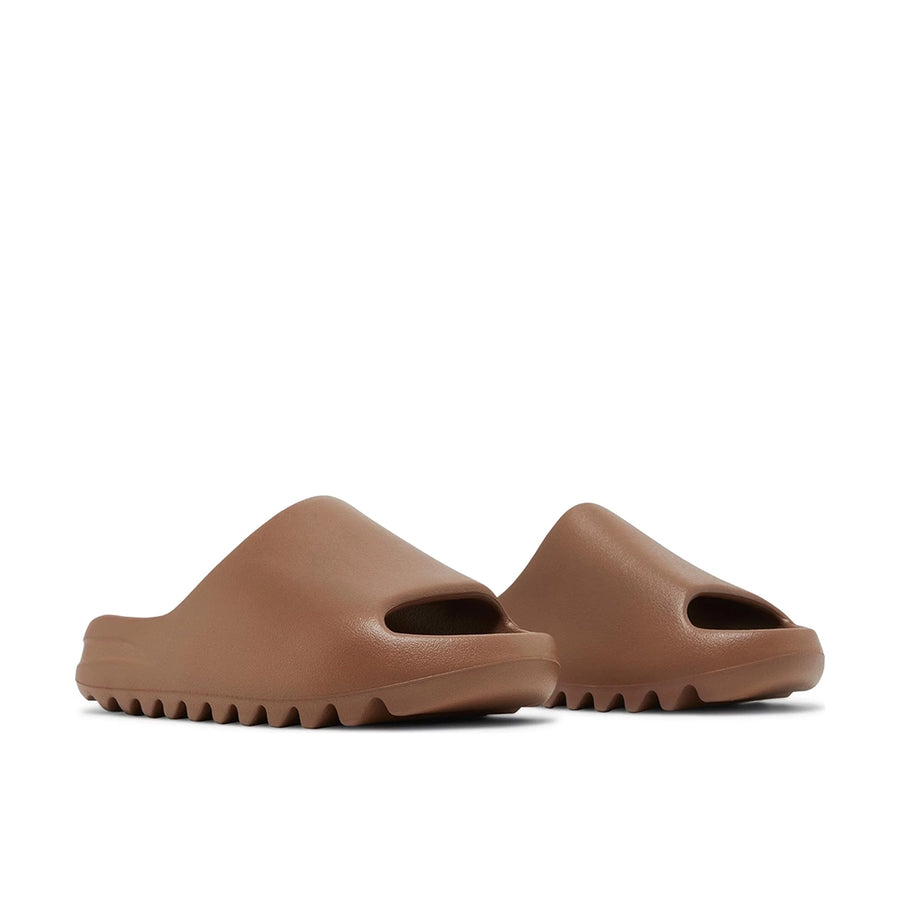 A pair of adidas Yeezy Slide Flax sneakers
