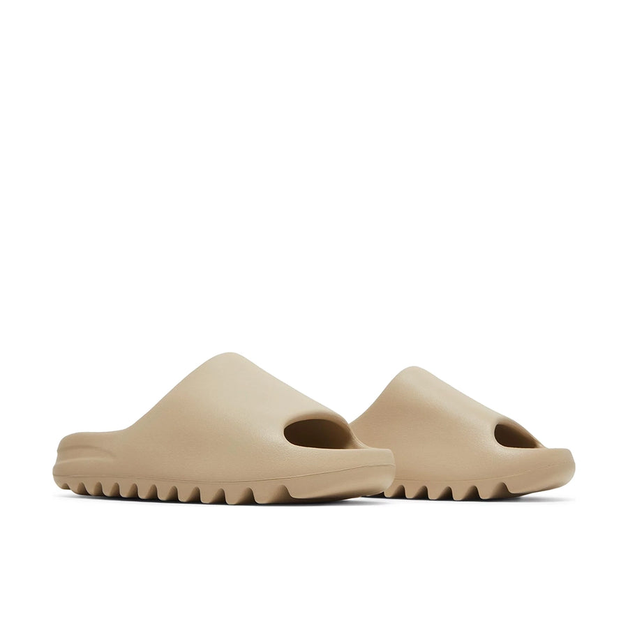 A pair of adidas Yeezy Slide Pure sneakers