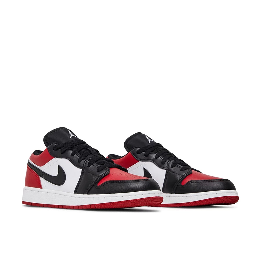 Pair of Jordan 1 Low Bred Toe (GS) in red, white and black.