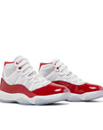 Pair of Jordan 11 Retro Cherry (2022) in red and white