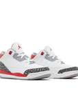 A pair of Toddler Nike Jordan Air 3 basketball shoes in a white and fire red colour
