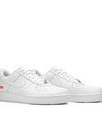 A pair of Nike Air Force 1 Low Supreme White sneaker in white