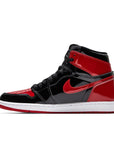 Side of Nike Air Jordan 1 High OG Patent Bred basketball shoes in black and red