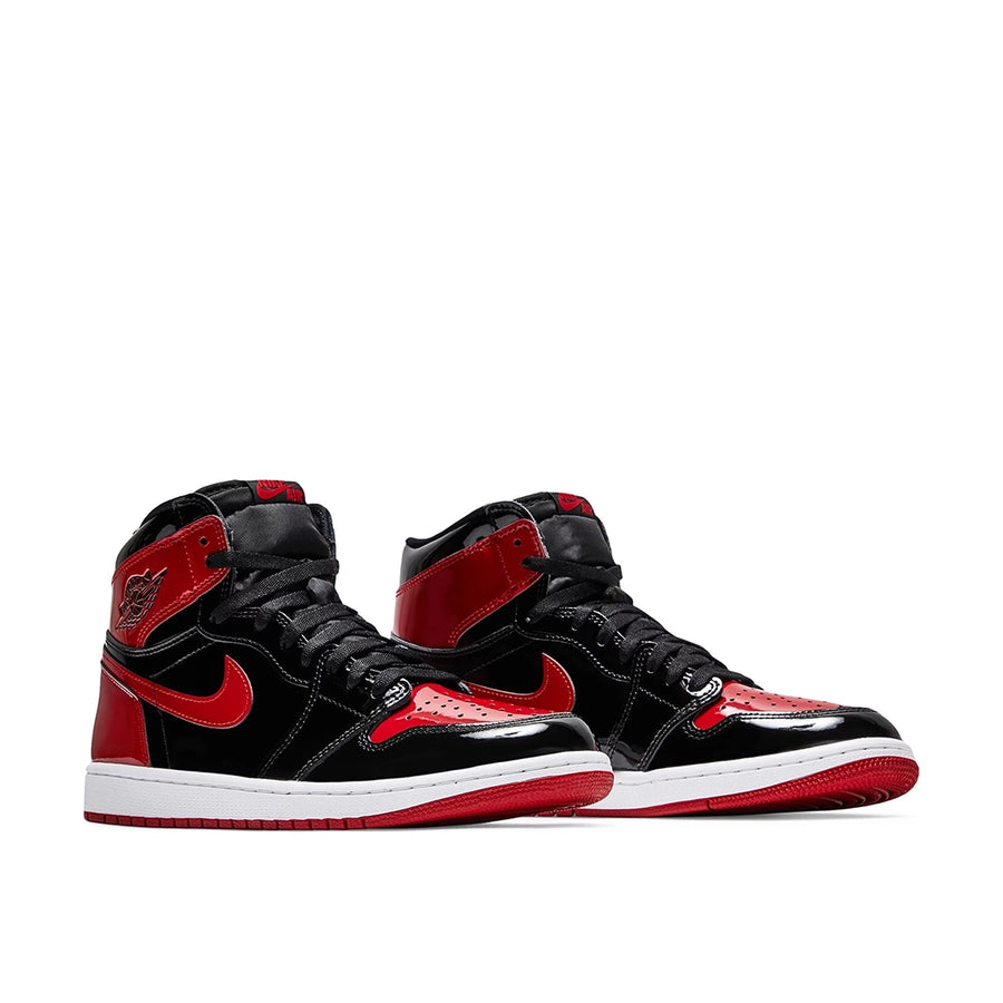 A pair of Nike Air Jordan 1 High OG Patent Bred basketball shoes in black and red