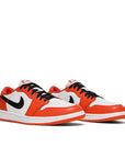 A pair of Nike Air Jordan 1 Low Starfish sneakers in orange and white