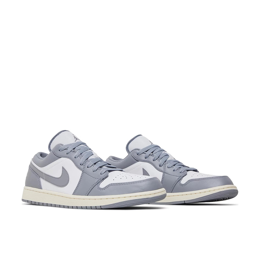 A pair of Nike Air Jordan 1 Low Vintage Grey Basketball Shoes in grey and white