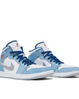 A pair of the Nike Jordan Air 1 mid basketball shoes are in a blue and fiery red colourway.