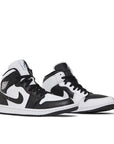 A pair of Jordan 1 Mid 'Split Black White' is in a black and white colourway