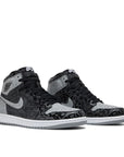A pair of Nike Air Jordan 1 basketball shoes in black grey and red rebellionaire colour