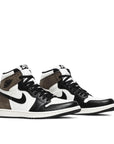 A pair of Nike Air Jordan 1 Retro High Dark Mocha Michael Jordans in white, black and mocha