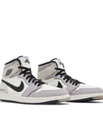 A pair of Nike Air Jordan 1 Retro High Element Gore-Tex Light Bone basketball shoes cream, grey and black