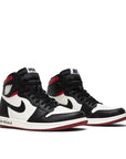 A pair of Nike Air Jordan 1 Retro High Not for Resale basketball shoes in varisty red, black and white
