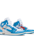 A pair of Nike Air Jordan 1 Retro High Off-White University blue basketball shoes in blue and white
