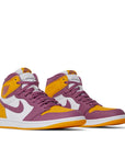 A pair of Nike Air Jordan 1 Retro High Brotherhood basketball shoes in gold, purple and white