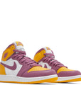 A pair of grade school Nike Air Jordan 1 Retro High OG Brotherhood GS basketball shoes in yellow, purple and white