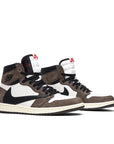 A pair of Nike Air Jordan 1 Retro High Travis Scott basketball shoes in mocha, white and black