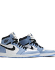 A pair of Nike Air Jordan 1 Retro High White University Blue Black basketball shoes in white and blue