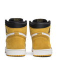 Heels of the Nike Air Jordan 1 High Yellow Ochre Michael Jordans in white, black and ochre
