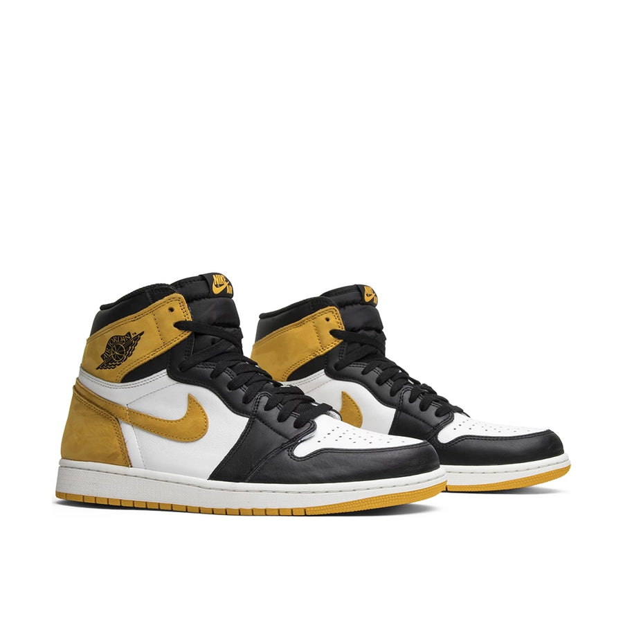A pair of Nike Air Jordan 1 High Yellow Ochre Michael Jordans in white, black and ochre