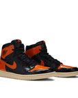 A pair of Nike Air Jordan 1 basketball shoes in black and orange shattered backboard colour