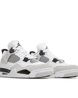 A pair of Nike Air Jordan 4 retro military black basketball shoes are in a white and black colourway.