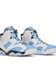 A pair of Nike Air Jordan 6 Retro UNC White basketball shoes in blue and white