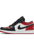 Side of the Nike Air Jordan 1 Low Bred Toe sneakers in black and red