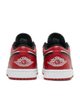 Heels of the Nike Air Jordan 1 Low Bred Toe sneakers in black and red