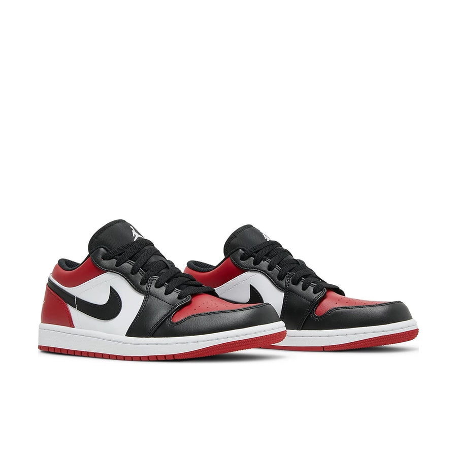 A pair of Nike Air Jordan 1 Low Bred Toe sneakers in black and red