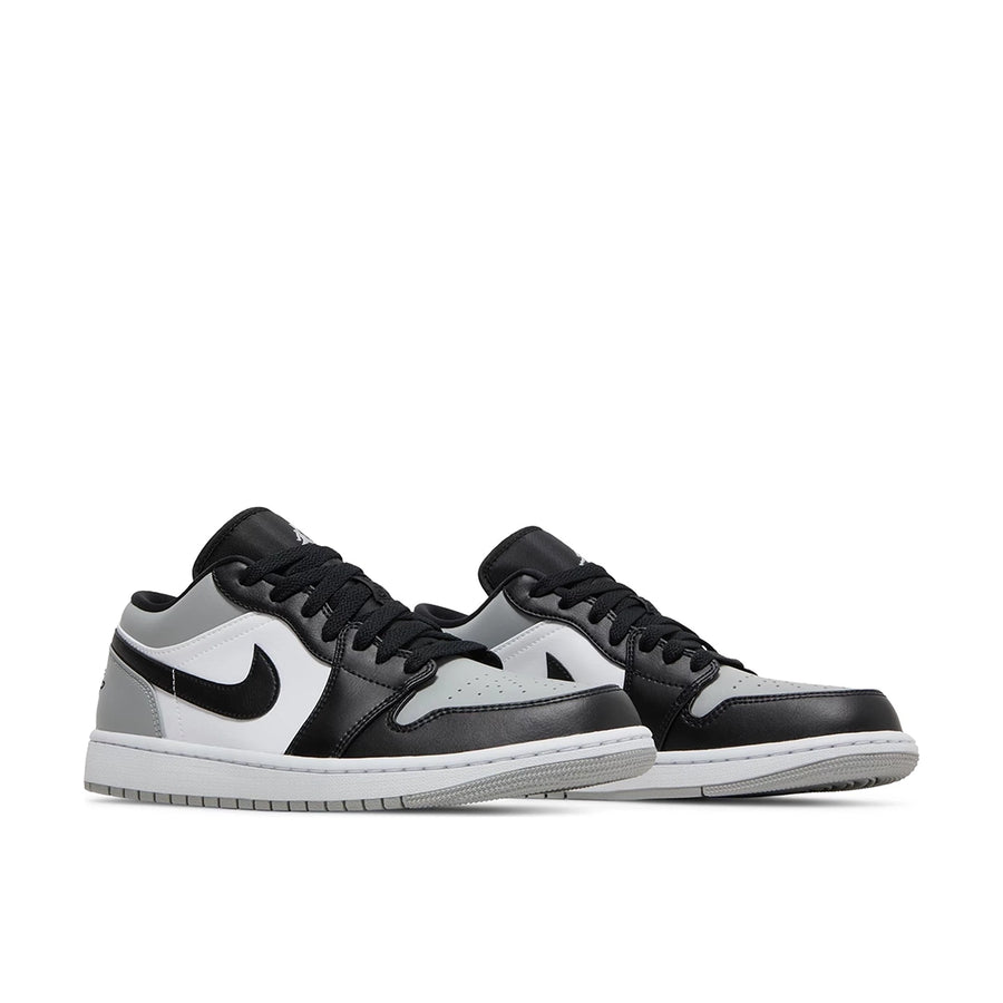 A pair of Nike Air Jordan 1 Low Shadow Toe sneakers in grey and black